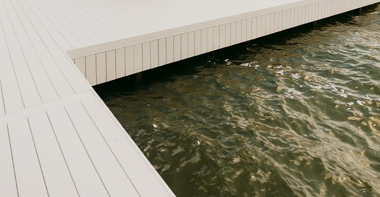 Owens Corning marine-grade decking boards on a boat dock over lake water